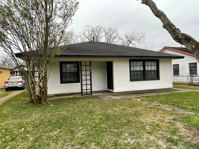 a house that has a large tree in front of it