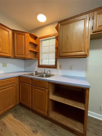 a kitchen with wooden cabinets and a sink