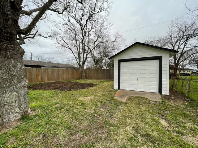a view of a house with a yard and garage