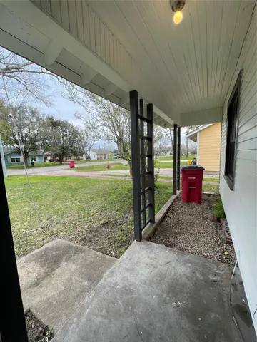 a view of a porch with furniture and garden