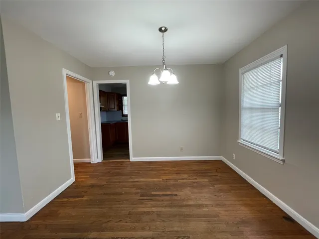 a view of a room window and wooden floor