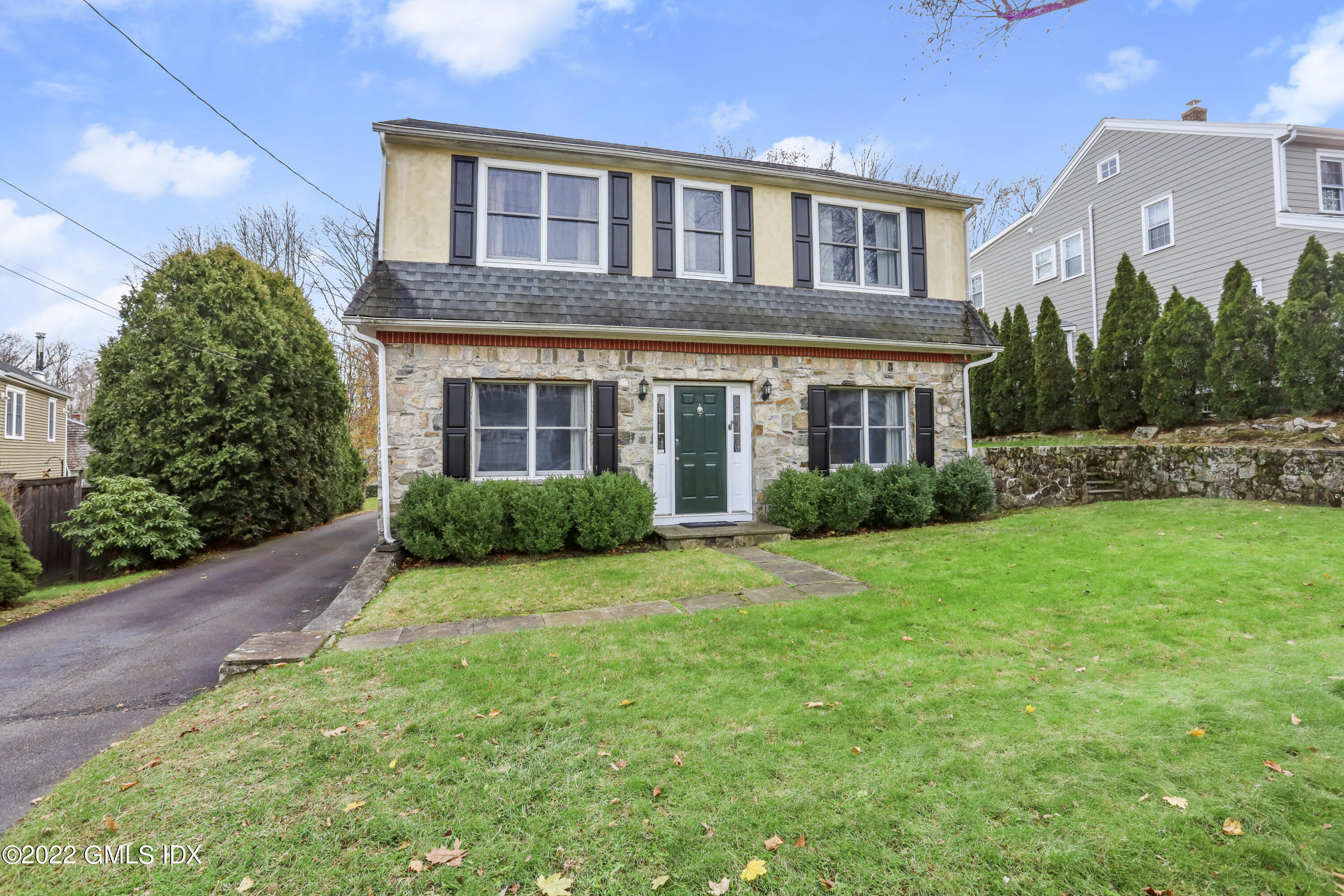24 Sunshine Avenue Riverside, CT 06878 - Photo 1 of 44 a front view of a house with a yard and outdoor seating
