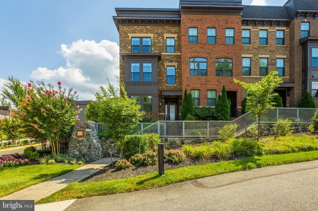 a view of a brick building next to a yard