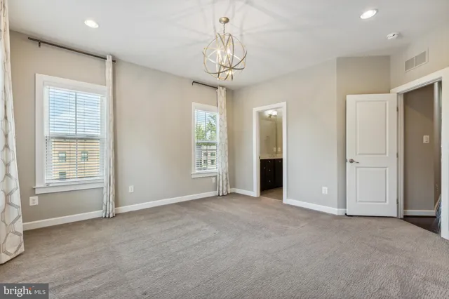 an empty room with windows and entrance