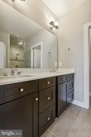 a bathroom with a sink vanity and a mirror
