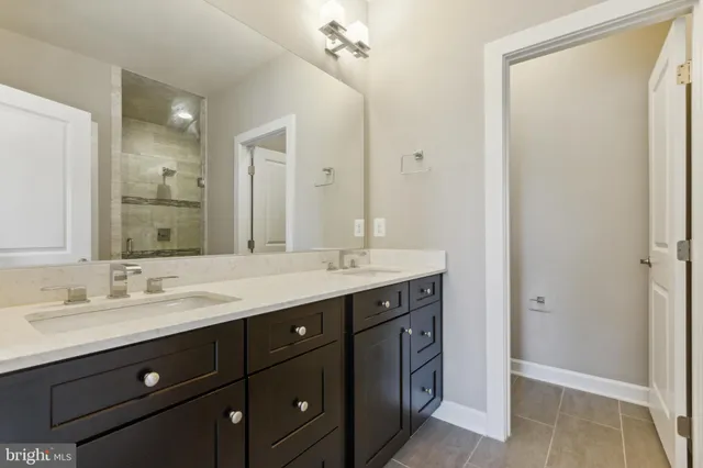a bathroom with a double vanity sink and a mirror