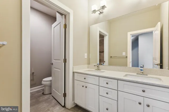 a bathroom with a double vanity sink and a mirror
