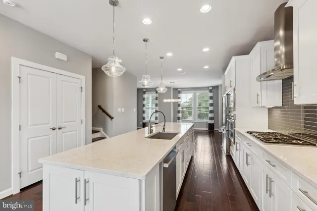 a kitchen with counter top space stove sink and refrigerator