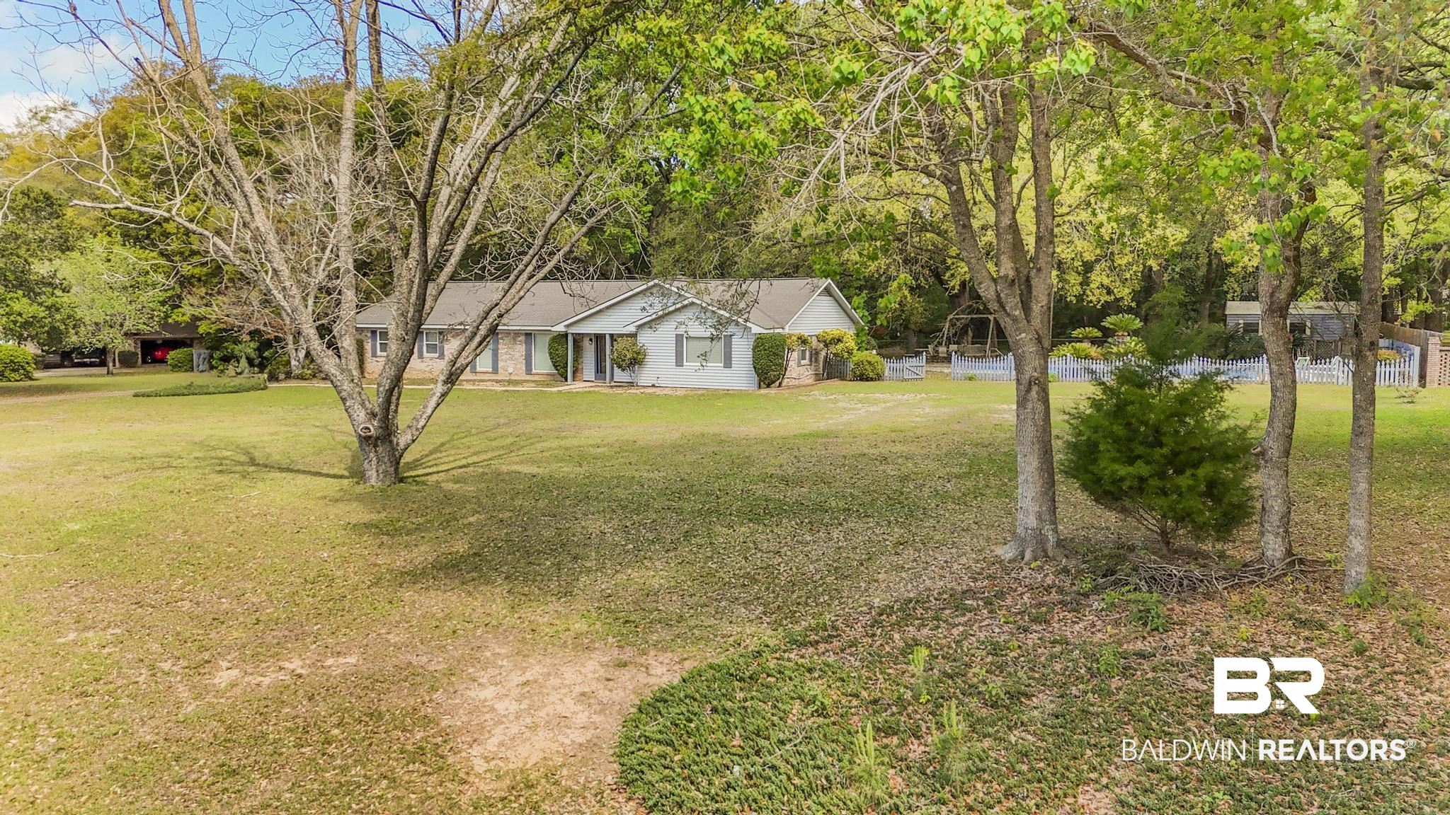 10207 Plantation Drive Daphne, AL 36526 - Photo 6 of 48 View of front of home with a front yard and view of scattered trees