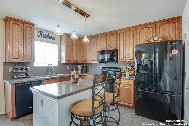a kitchen with stainless steel appliances a refrigerator sink and cabinets