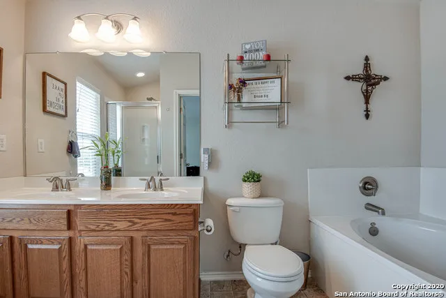 a bathroom with a granite countertop sink mirror toilet and bathtub