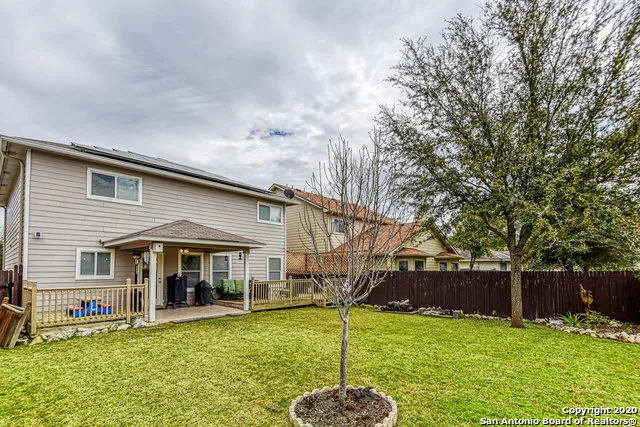 a backyard of a house with yard table and chairs