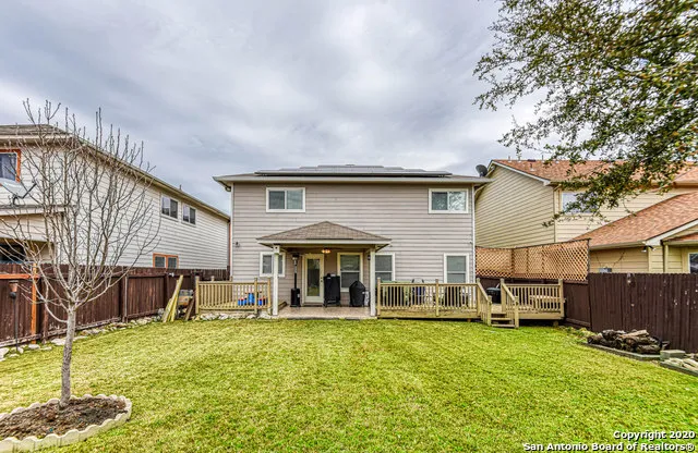 a backyard of a house with yard table and chairs