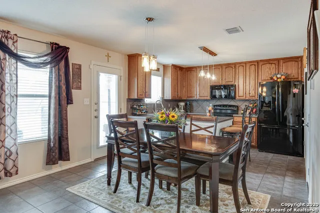 a view of a dining room with furniture and window
