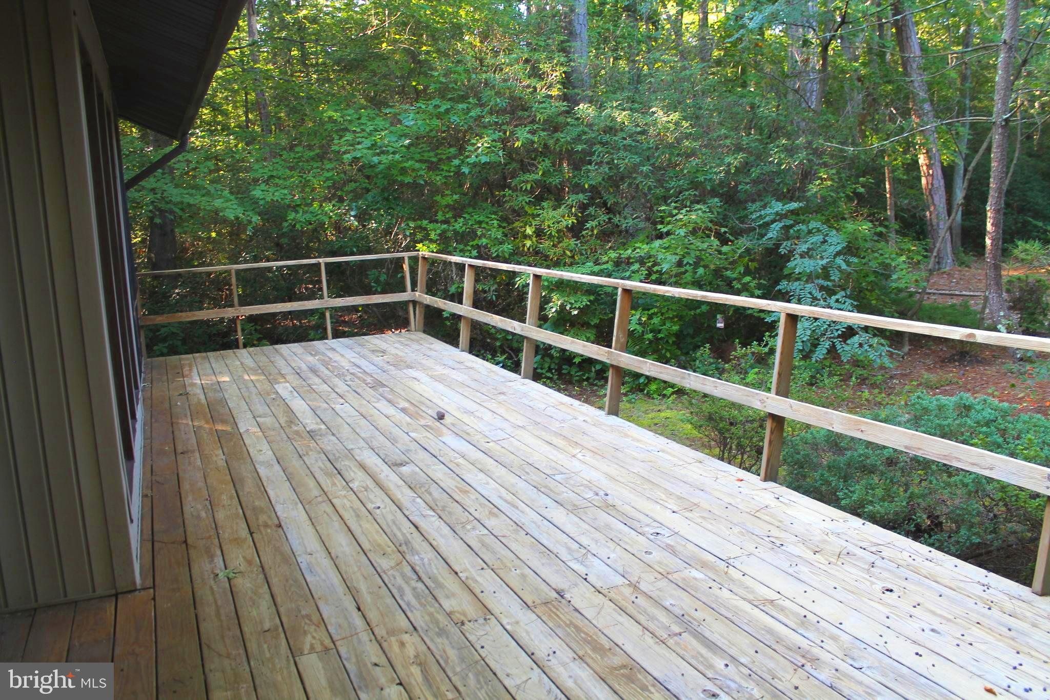 183 Sandyhook Road Ocean Pines, MD 21811 - Photo 2 of 15 a view of wooden deck and a garden