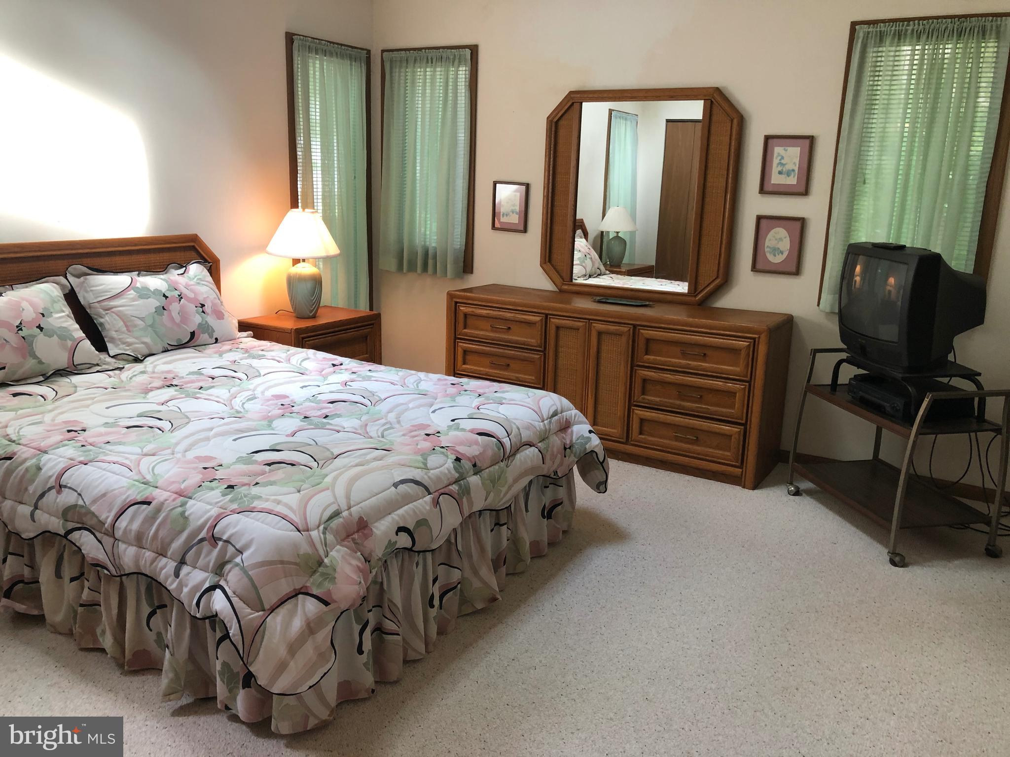 183 Sandyhook Road Ocean Pines, MD 21811 - Photo 11 of 15 a bedroom with a bed and a mirror on dresser