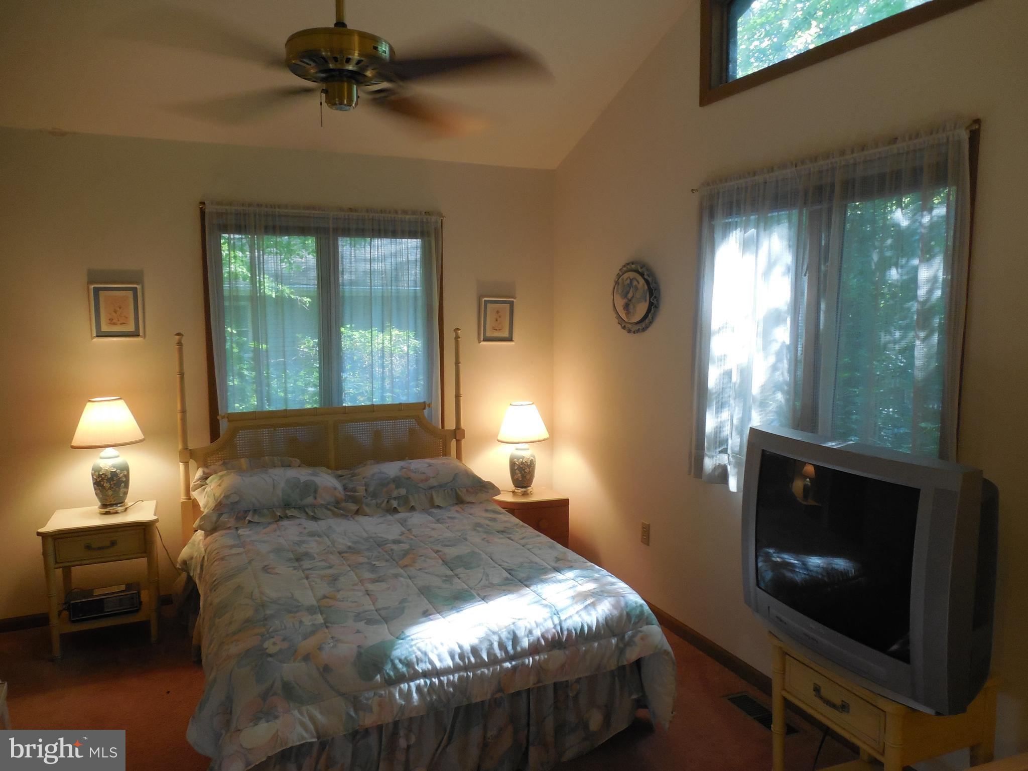 183 Sandyhook Road Ocean Pines, MD 21811 - Photo 13 of 15 a bedroom with a bed and a fireplace