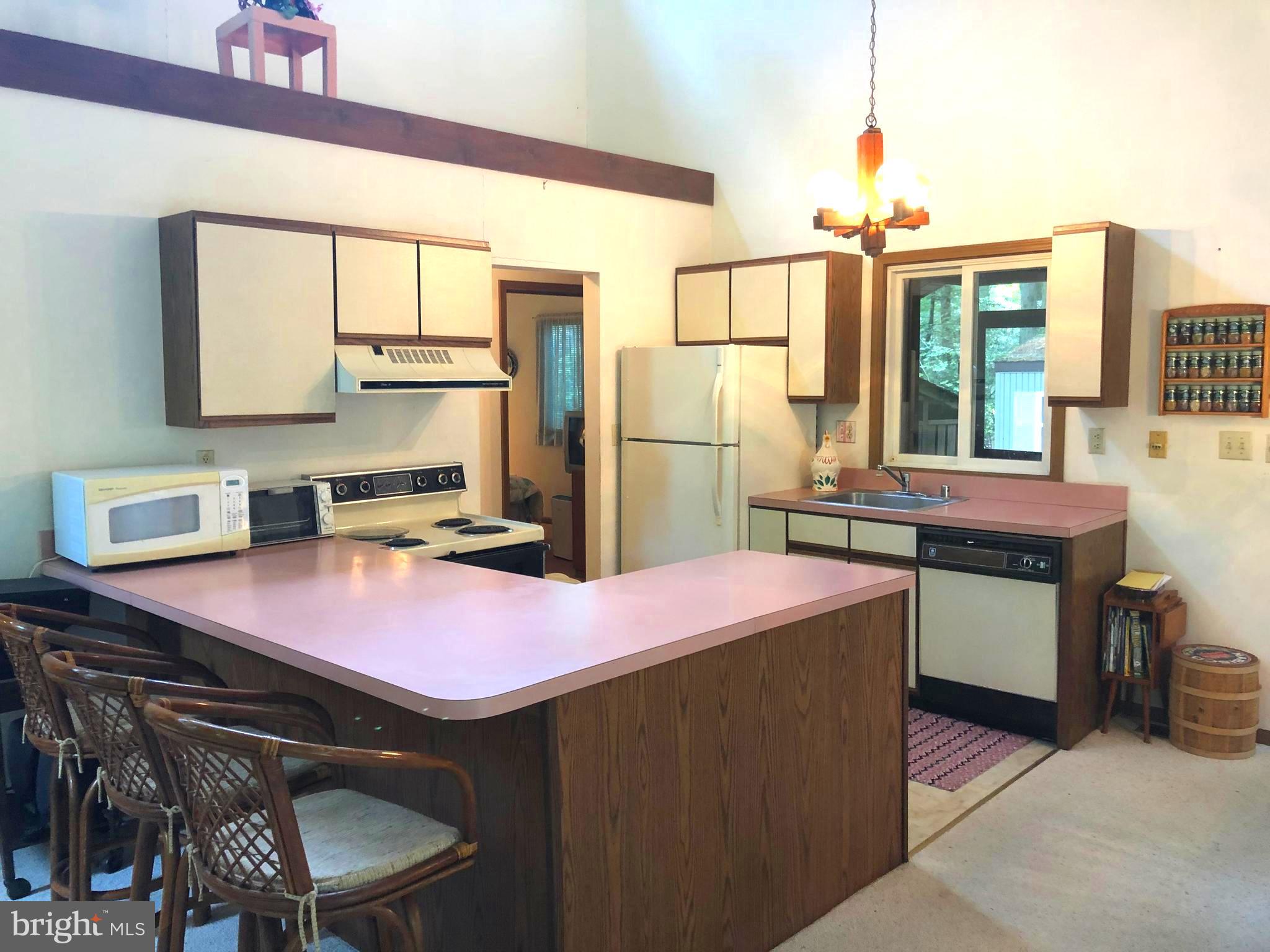 183 Sandyhook Road Ocean Pines, MD 21811 - Photo 5 of 15 a kitchen with a sink stove and refrigerator