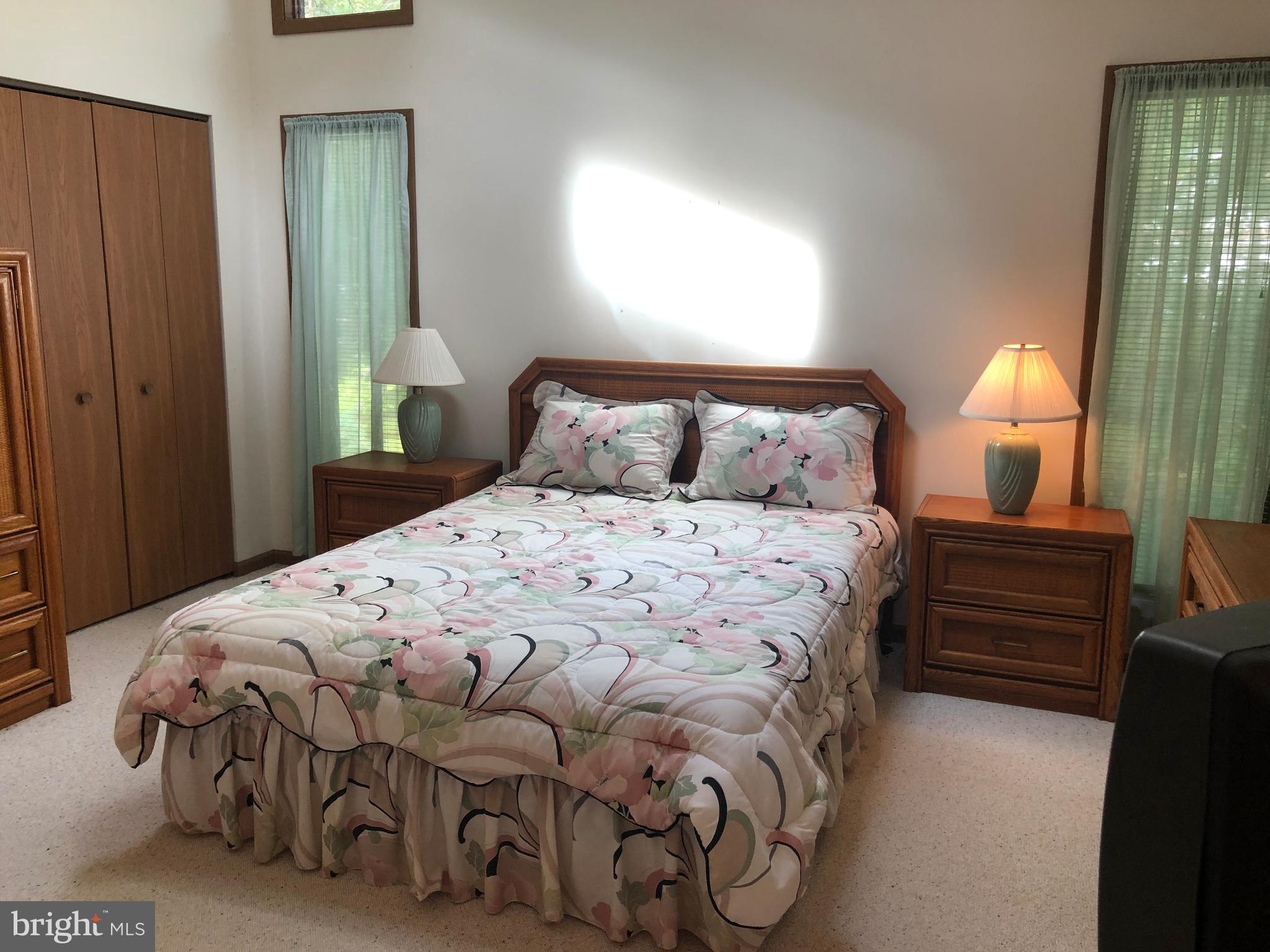 183 Sandyhook Road Ocean Pines, MD 21811 - Photo 10 of 15 a bedroom with a bed and a lamp