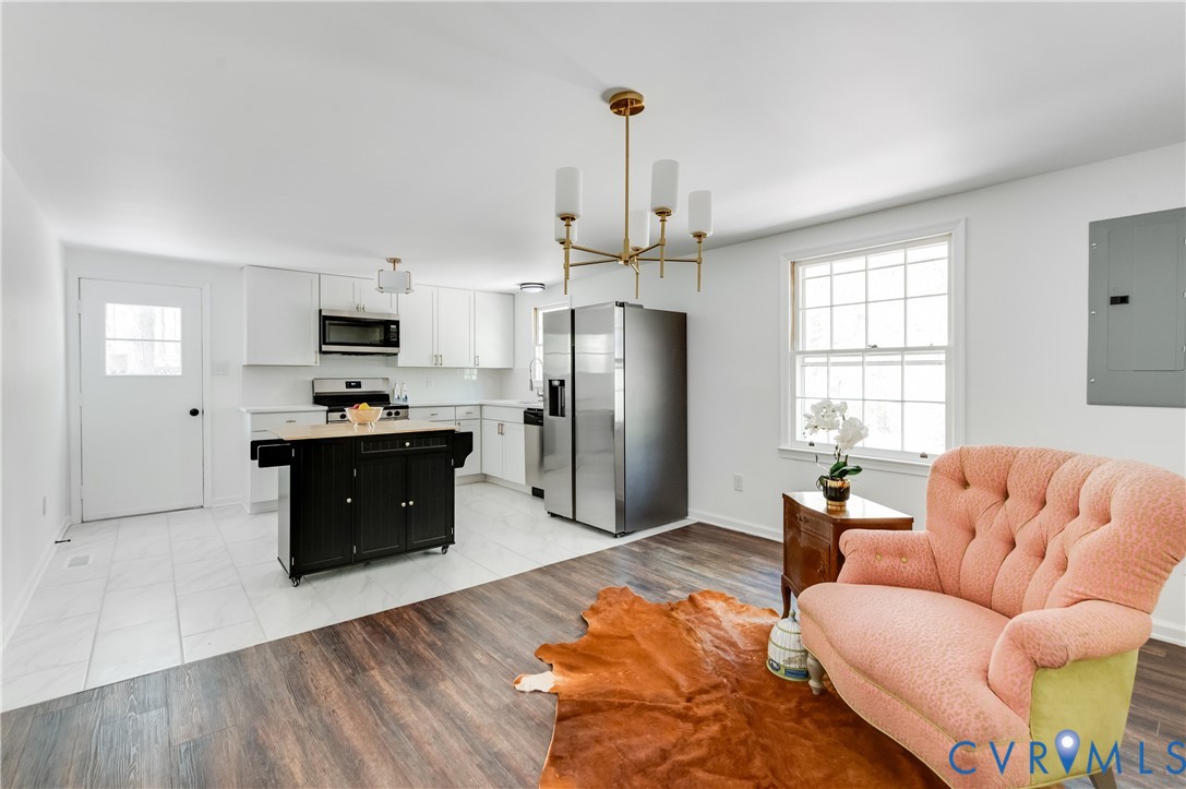 26 Liberty Tree Lane Hanover, VA 23069 - Photo 11 of 38 a large living room with stainless steel appliances granite countertop furniture a fireplace a flat screen tv and a window