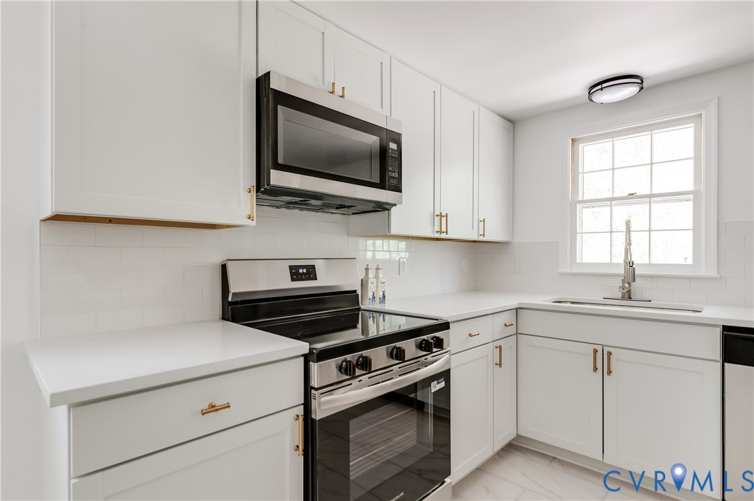 26 Liberty Tree Lane Hanover, VA 23069 - Photo 19 of 38 a kitchen with white cabinets and appliances