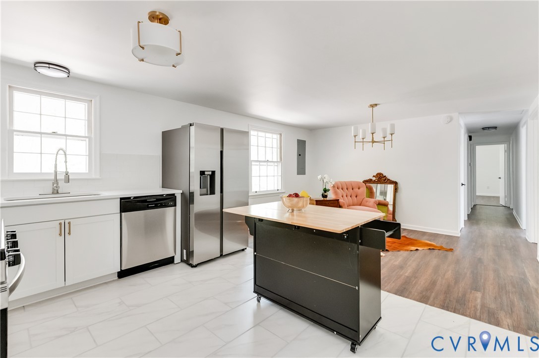 26 Liberty Tree Lane Hanover, VA 23069 - Photo 20 of 38 a kitchen with stainless steel appliances a sink a stove a refrigerator cabinets and a dining table