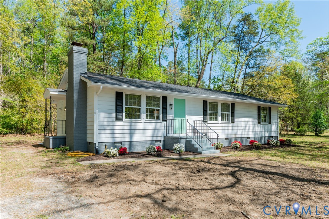 26 Liberty Tree Lane Hanover, VA 23069 - Photo 2 of 38 a front view of a house with a yard and seating space