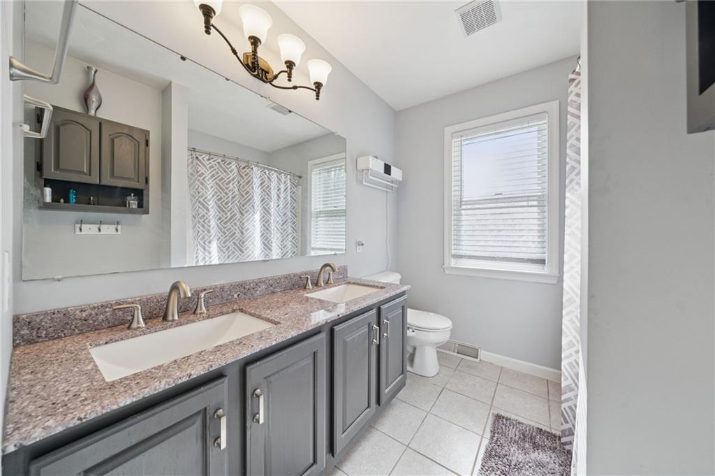 227 Sandworks Road Hunker, PA 15639 - Photo 21 of 41 a bathroom with a granite countertop sink a toilet and mirror
