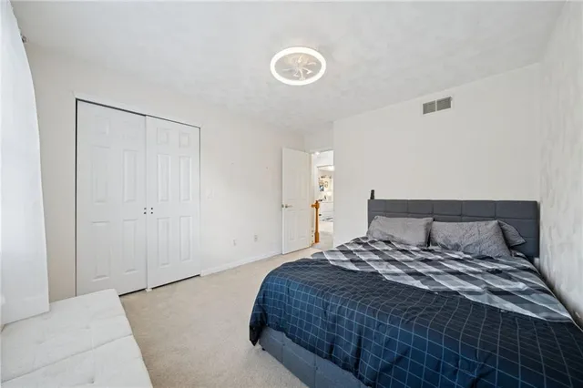 a bedroom with a bed and window