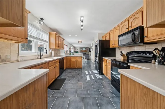 a large kitchen with stainless steel appliances lots of counter space and a sink