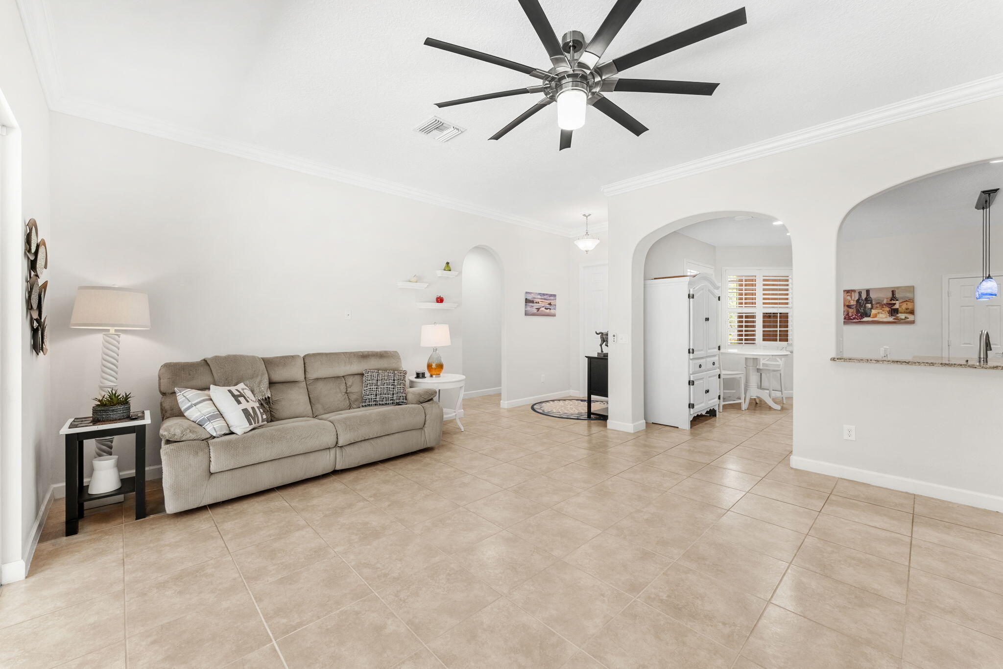 7657 Fieldstone Ranch Square Vero Beach, FL 32967 - Photo 12 of 52 a living room with furniture and a chandelier