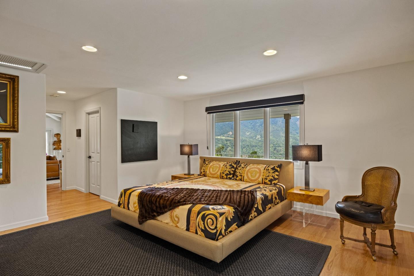 27 La Rancheria Carmel Valley, CA 93924 - Photo 13 of 30 a bedroom with a bed and a chair