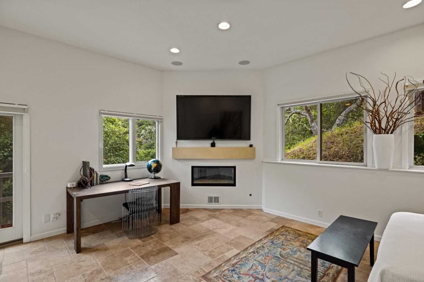 27 La Rancheria Carmel Valley, CA 93924 - Photo 18 of 30 a living room with furniture a flat screen tv and a fireplace