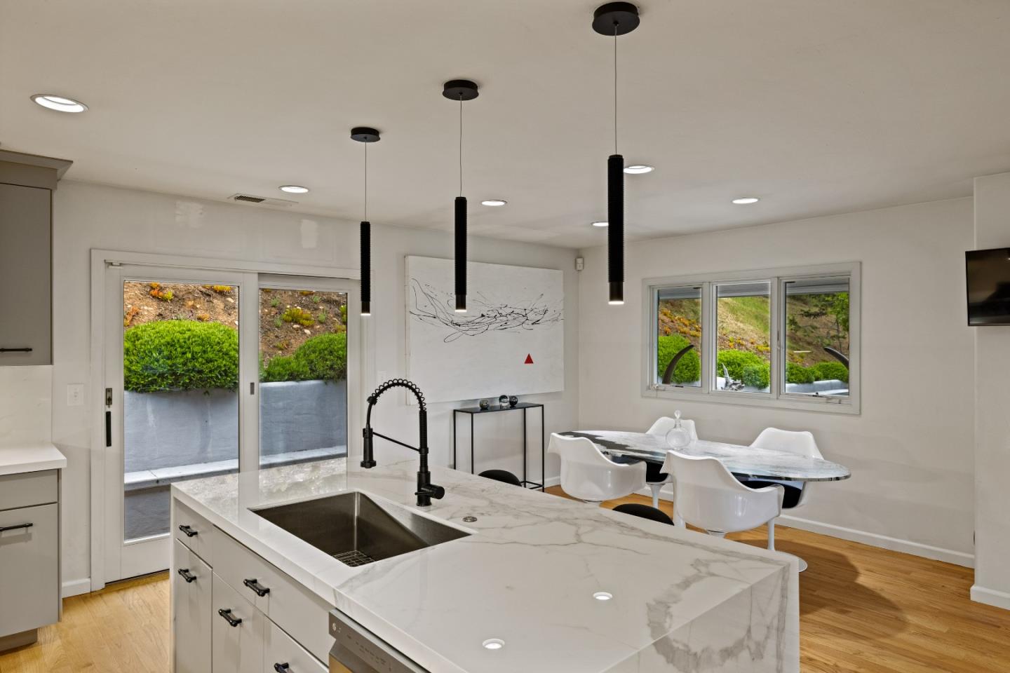 27 La Rancheria Carmel Valley, CA 93924 - Photo 8 of 30 a kitchen with stainless steel appliances a sink a counter space and a wooden floor