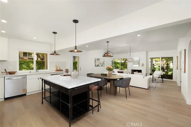 a living room with furniture a bed and a chandelier