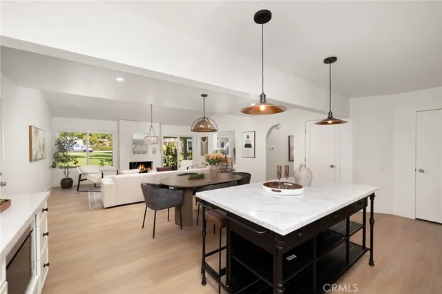 a kitchen with a table a dining table and chairs