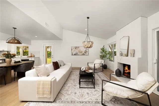 a living room with furniture and a chandelier