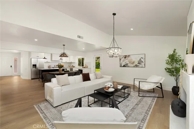a living room with furniture and kitchen view