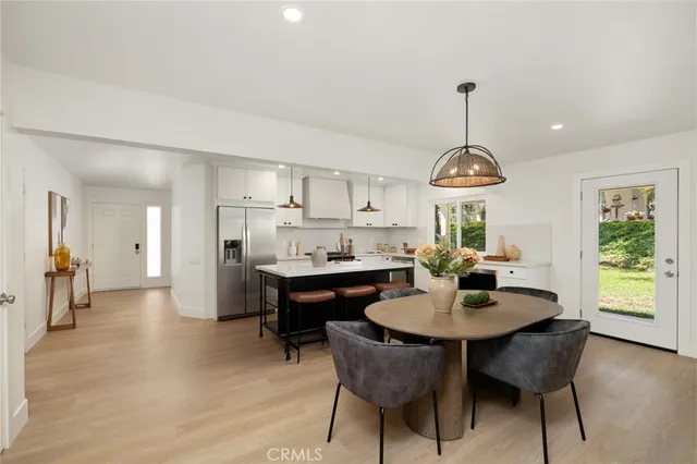 a large kitchen with a table and chairs
