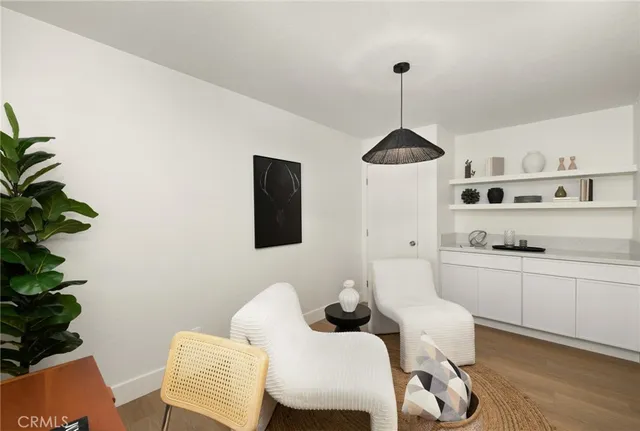 a living room with furniture a chandelier and a rug