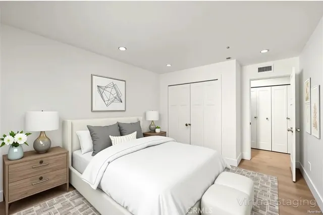 a bedroom with a bed and painting on the wall