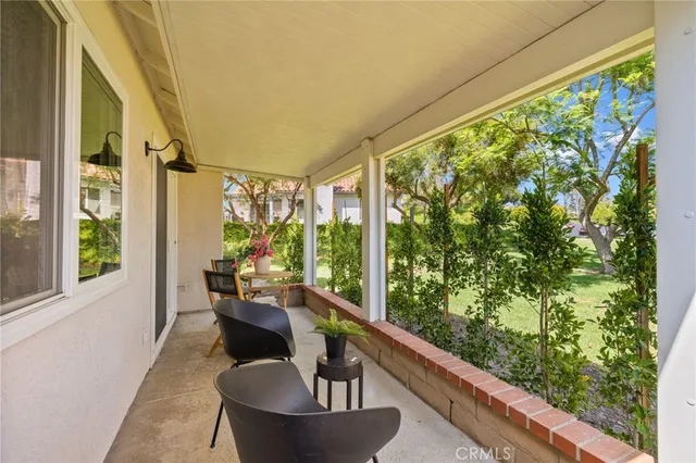 a balcony with chairs and city view