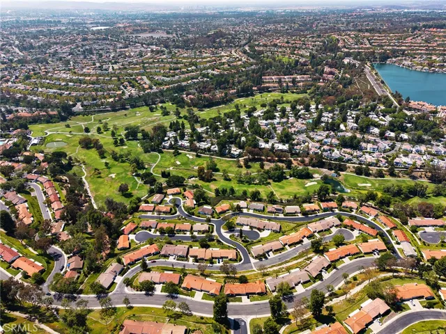 an aerial view of residential houses with city view