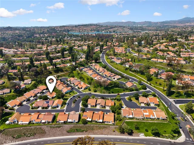 an aerial view of residential houses with outdoor space and street view