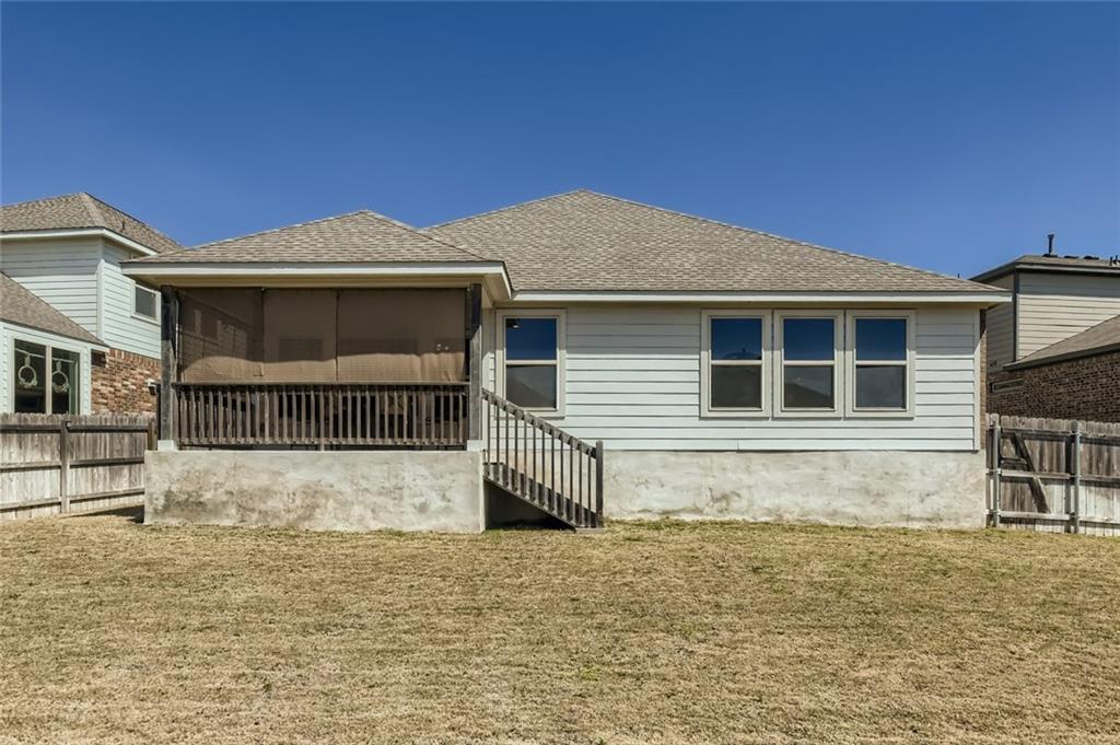 6752 Catania Loop Round Rock, TX 78665 - Photo 23 of 25 Rear view of house featuring a fenced backyard, a sunroom, and roof with shingles