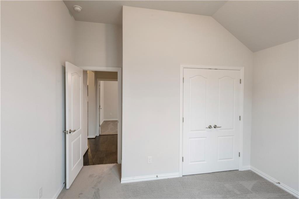 6752 Catania Loop Round Rock, TX 78665 - Photo 9 of 25 Unfurnished bedroom featuring light carpet, vaulted ceiling, and a closet