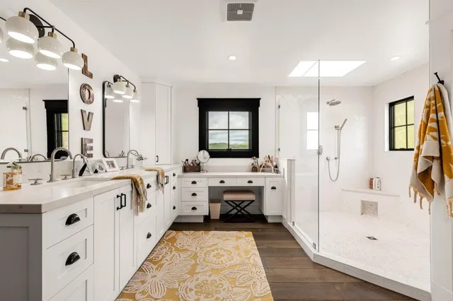 a front view of a house with a yard and potted plants