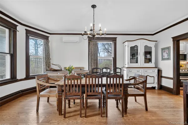 a view of a dining room with furniture window and wooden floor