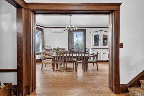 a dining room with a wooden table and chairs