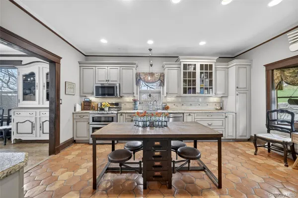 a view of a a dining room with furniture window and wooden floor